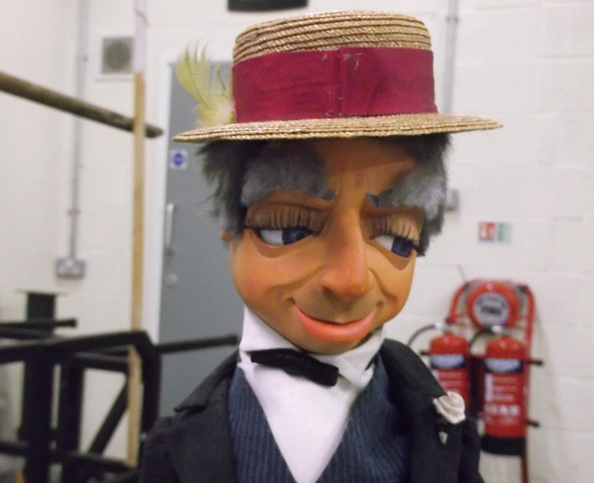 Parker, Lady Penelope's butler from Thunderbirds, a puppet in a straw boater, bow tie and waistcoat with a watch chain